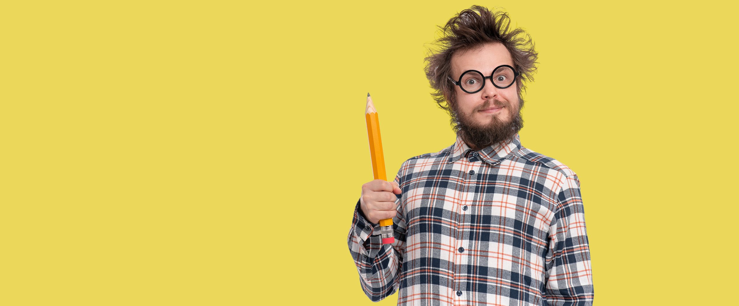 Beadrd man holding a pencil