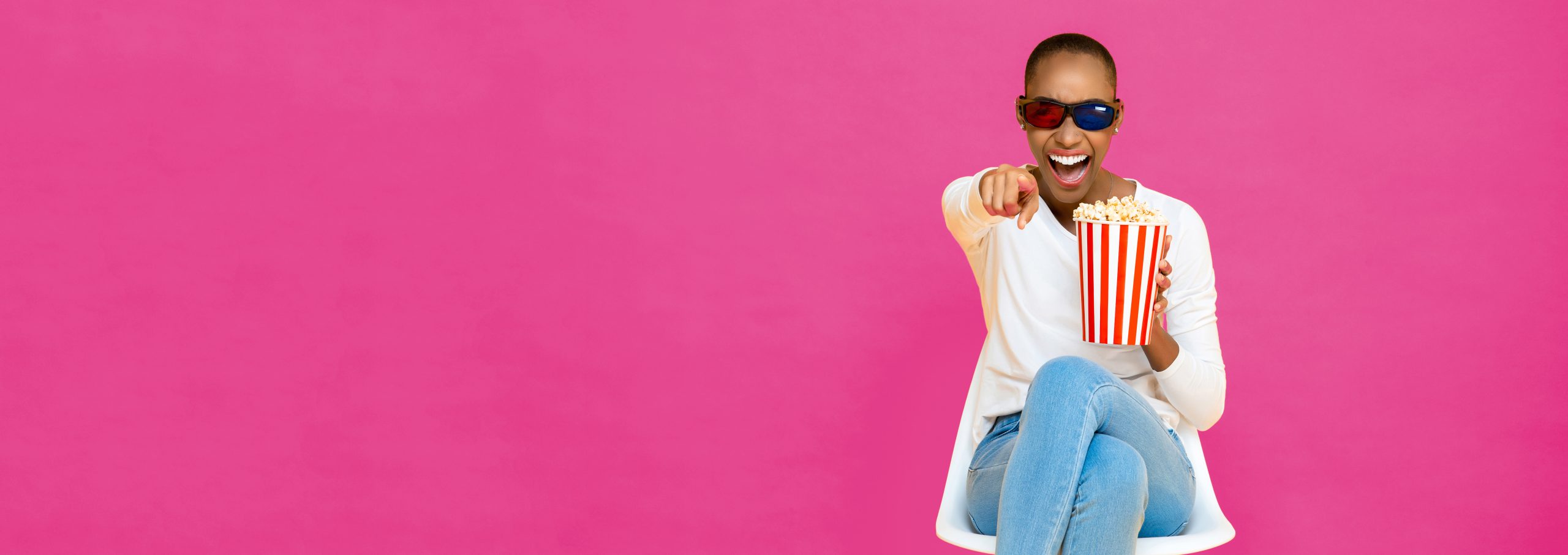 Women laughing while holding popcorn