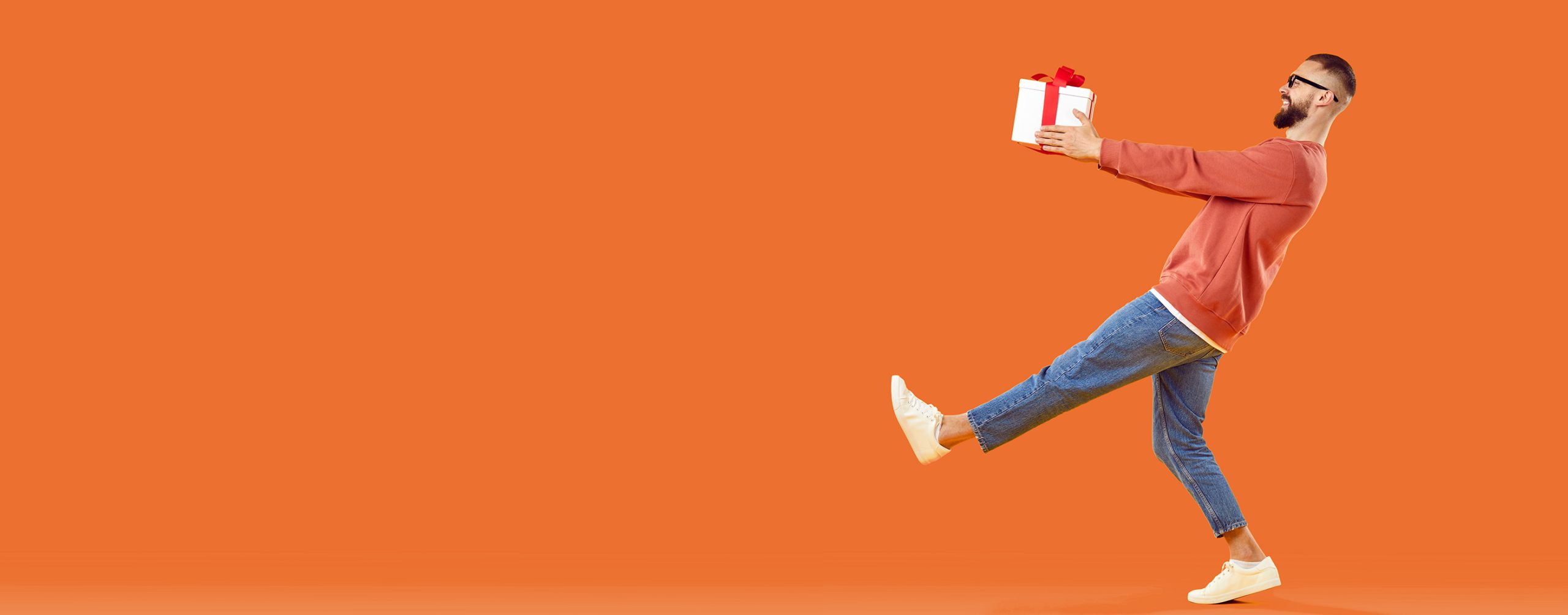 Happy man carrying a gift box.